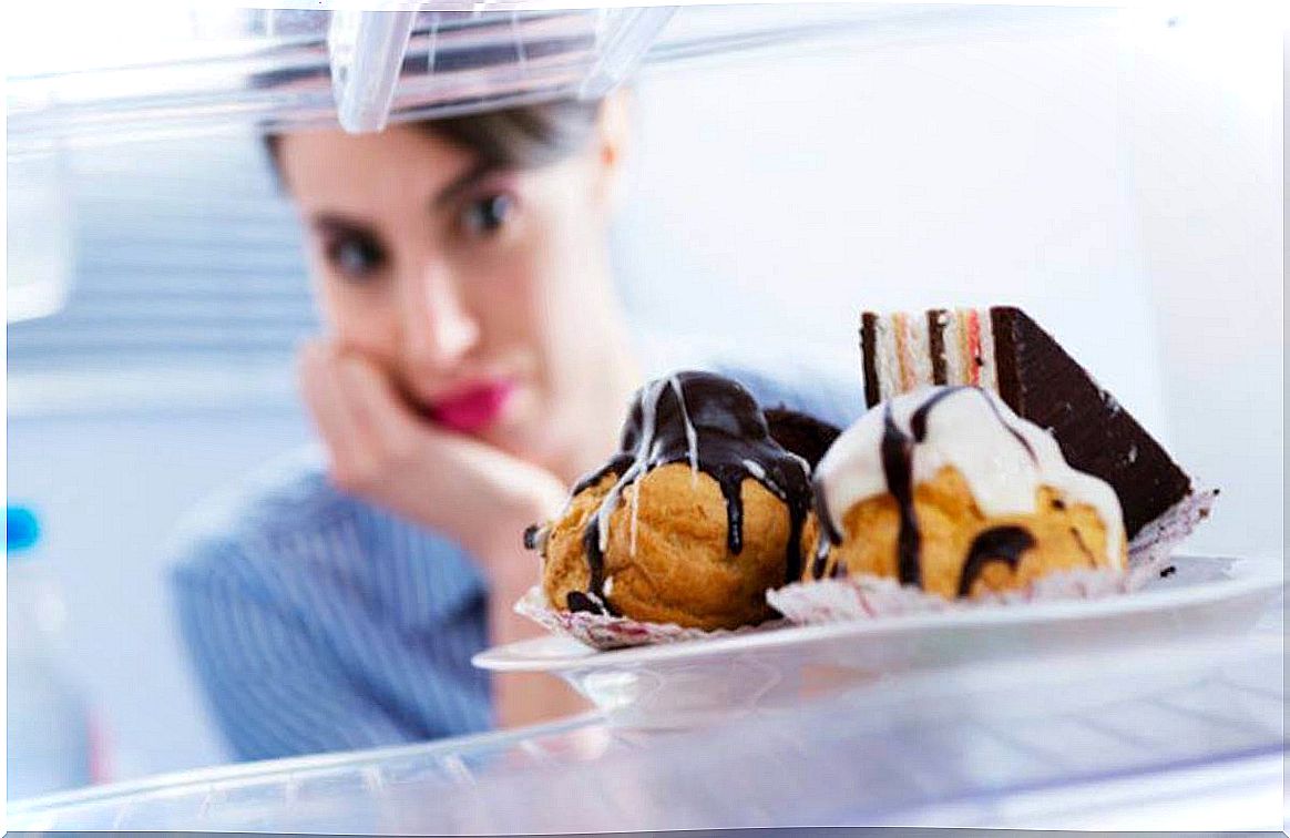 Woman looking at sweets in the fridge