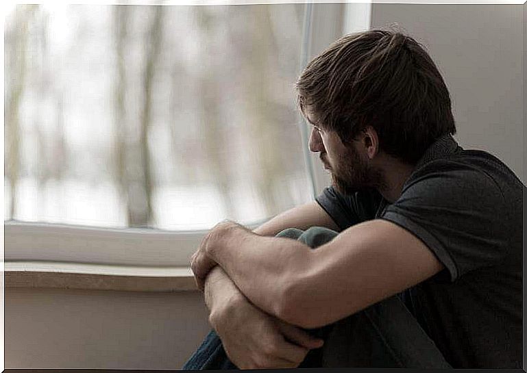 Man looking out the window with apathy