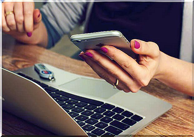 woman working consulting her smartphone