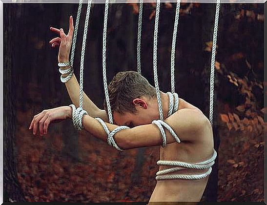 man tied by ropes