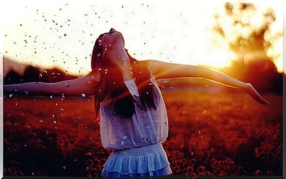 Woman spreading arms in happiness