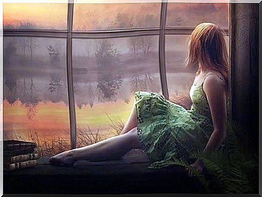 woman in green dress in front of a window