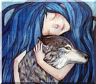 Girl with blue hair hugging a wolf