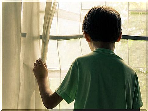 Intellectually disabled child looking out the window