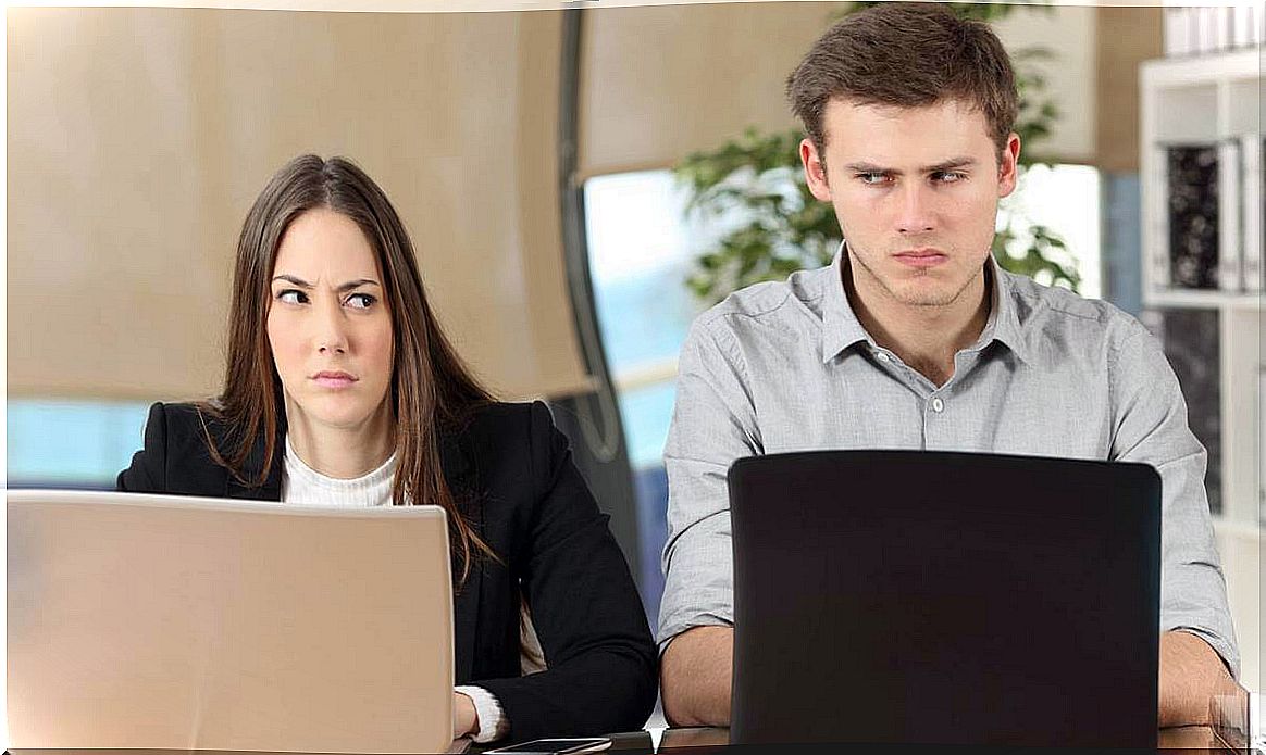 Employees at the computer thinking about interpersonal rudeness at work