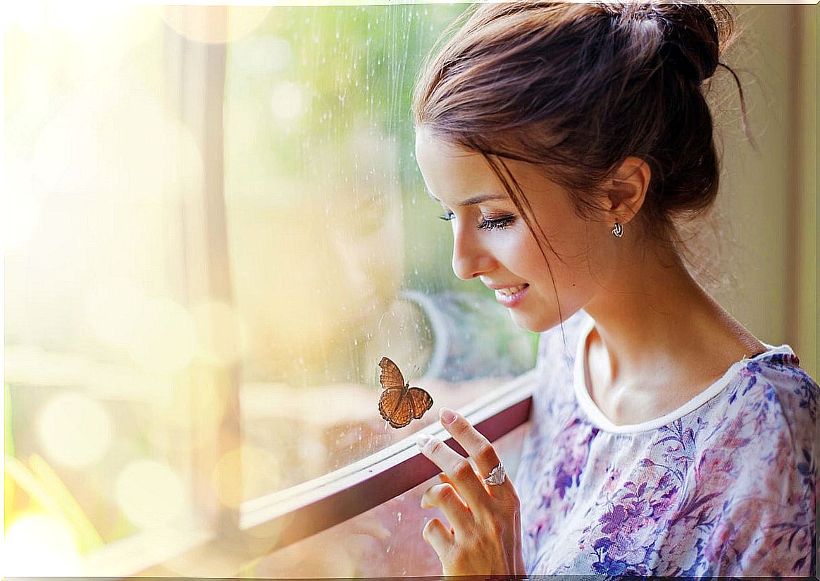 Woman touching a butterfly