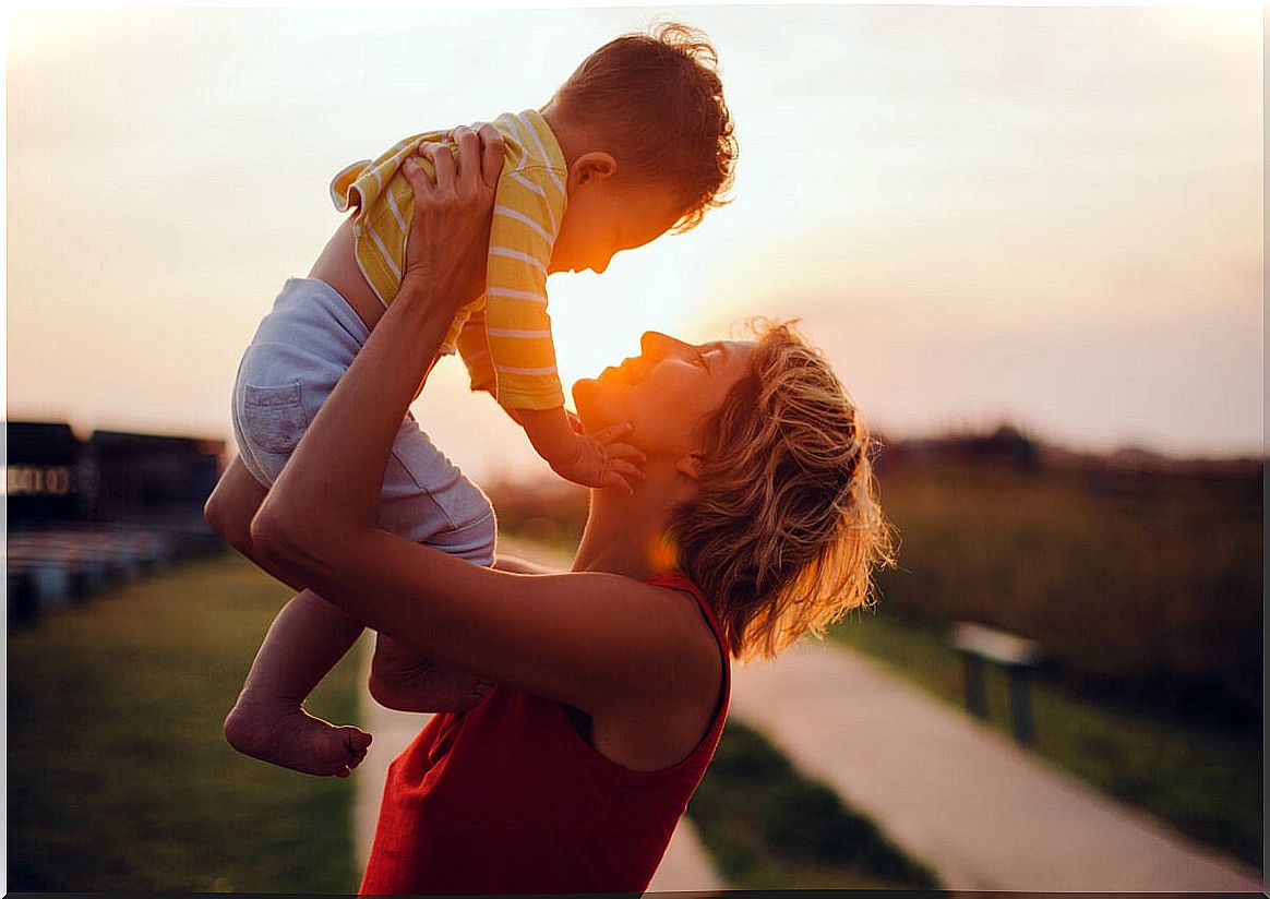 Mother holding her son in her arms