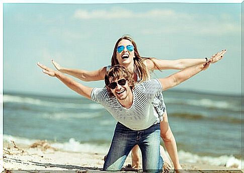 Couple playing at the beach