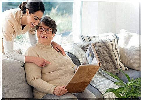 Woman with dementia talking to a young girl