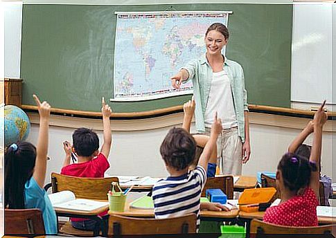 Teacher giving the word to children in class