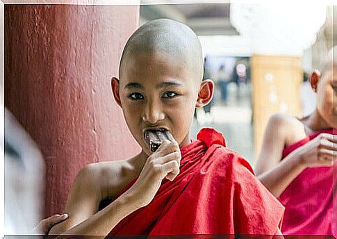 Buddhist boy eating chocolate ice cream