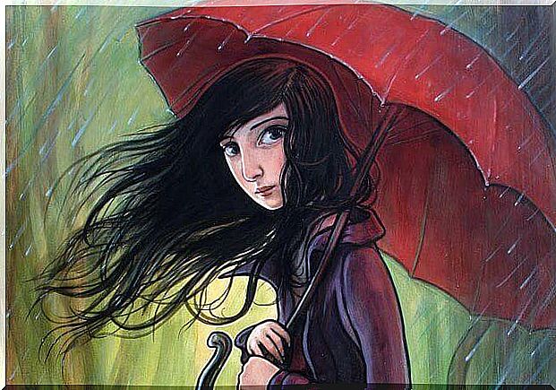 Girl with a red umbrella while it rains