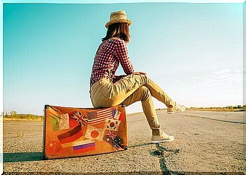 Woman sitting on a suitcase