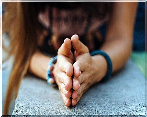 Woman with arms together to give thanks