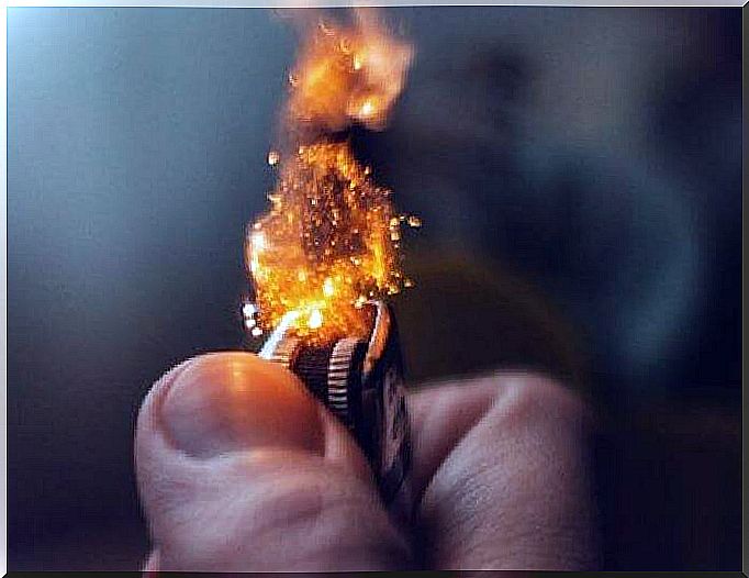 Hand lighting a lighter